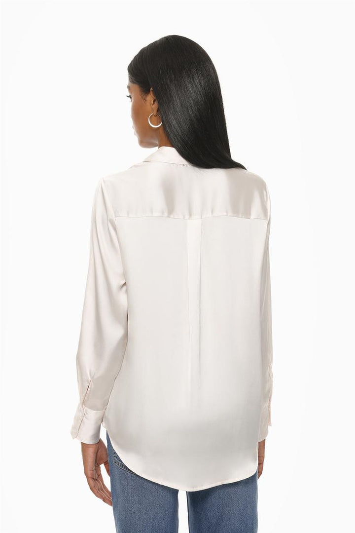 A back view of a white long-sleeve satin shirt, highlighting its smooth, glossy texture and seamless design. The shirt features a straight hem and relaxed fit, emphasizing its timeless and elegant style.