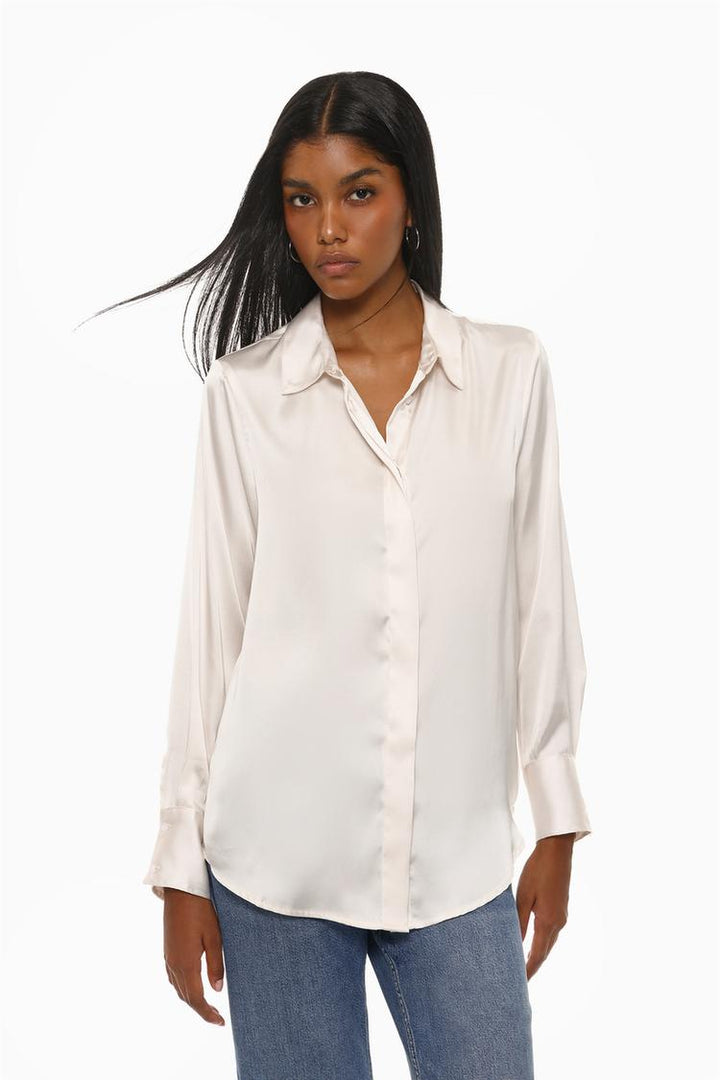 A front view of a white long-sleeve satin shirt, showcasing its luxurious sheen, classic button-up closure, and pointed collar. The smooth fabric and tailored fit add a touch of sophistication, perfect for both formal and casual occasions.