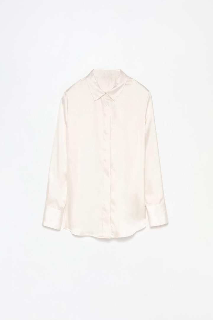 A professional product image of a white long-sleeve satin shirt, showcasing its smooth, glossy texture, button-down front, and classic collar. The shirt is displayed on a clean background to highlight its premium quality and elegant design.