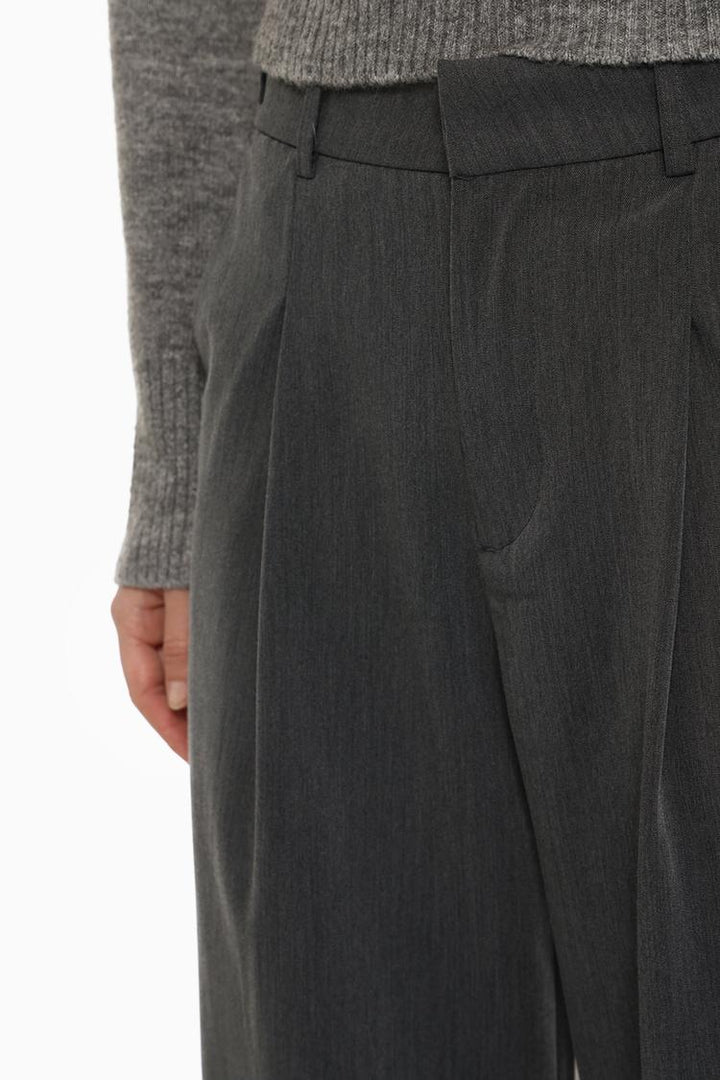 Front view of grey loose-fitting wide-leg trousers, designed for effortless chic