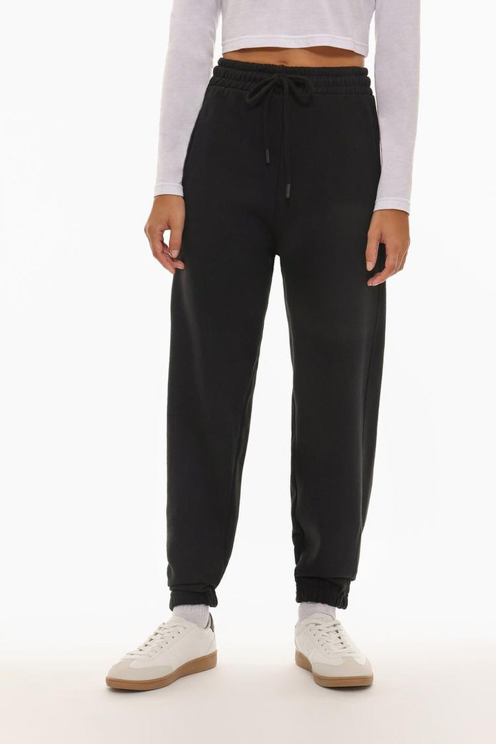 Front view of the black oversized tracksuit trousers, emphasizing the fit and style.