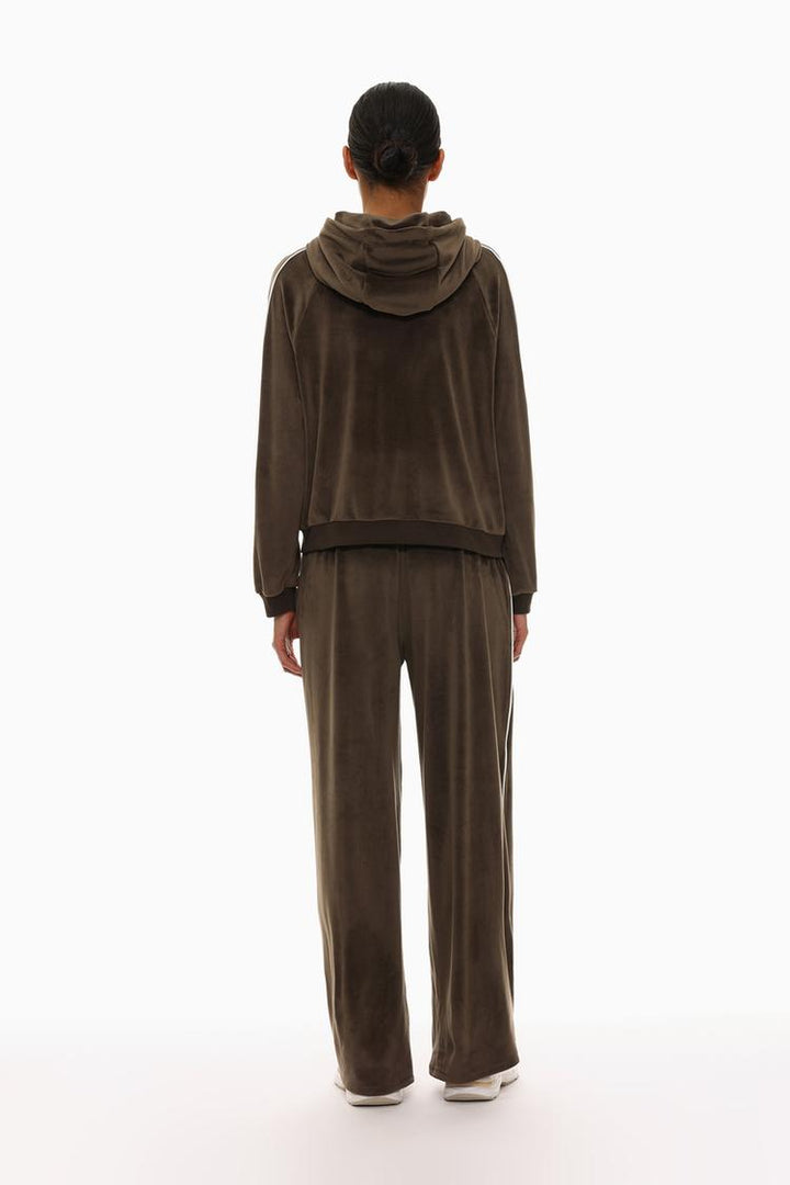 Brown oversized velvet trousers back view showcasing the fit and design.
