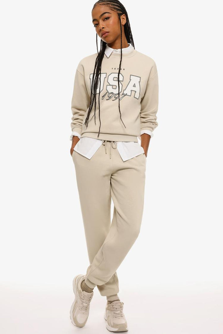 Beige plush joggers showcasing the soft fabric and relaxed fit.