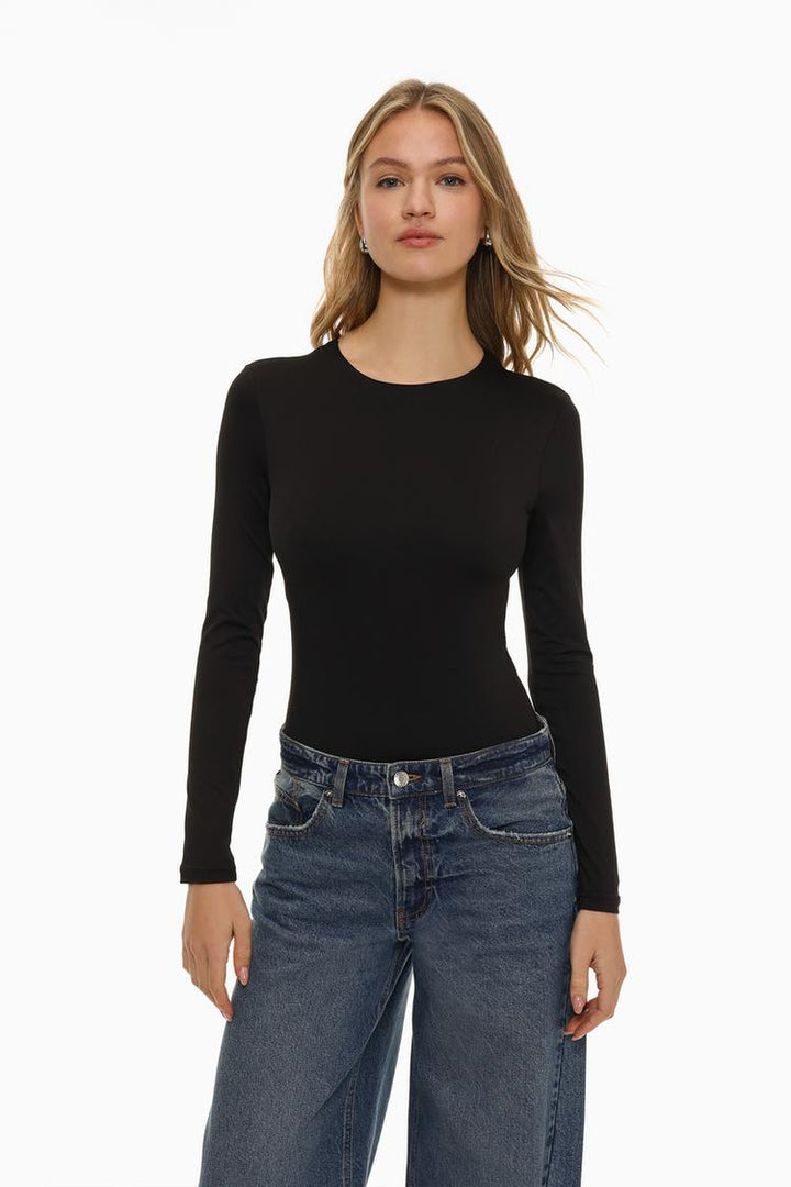 Elevate your wardrobe with this sleek black polyamide round neck bodysuit, designed for both comfort and style. The soft, stretchy polyamide fabric hugs the body for a smooth, flattering fit, while the classic round neck offers a timeless silhouette. Perfect for layering or wearing on its own, this versatile bodysuit is a must-have for any occasion, from casual outings to evening events.