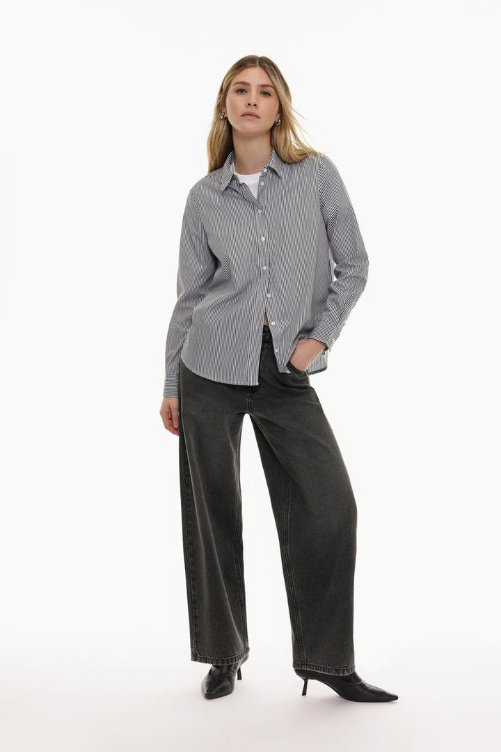 Full body view of a grey poplin shirt, highlighting its crisp, structured design and tailored fit.