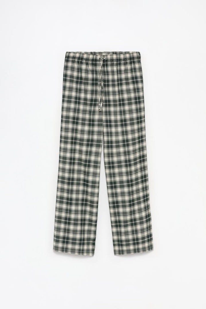 Full-product image of green printed jogging trousers, emphasizing their high-quality fabric and bold print.