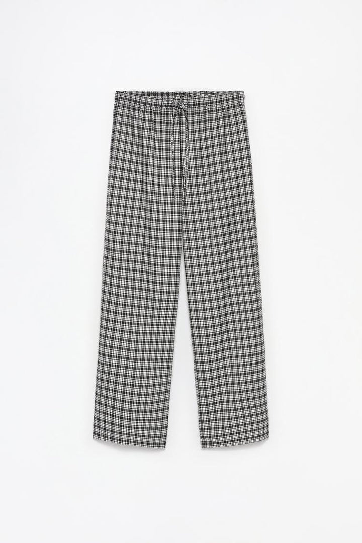 Full-product image of white printed jogging trousers, ideal for casual outings or loungewear.