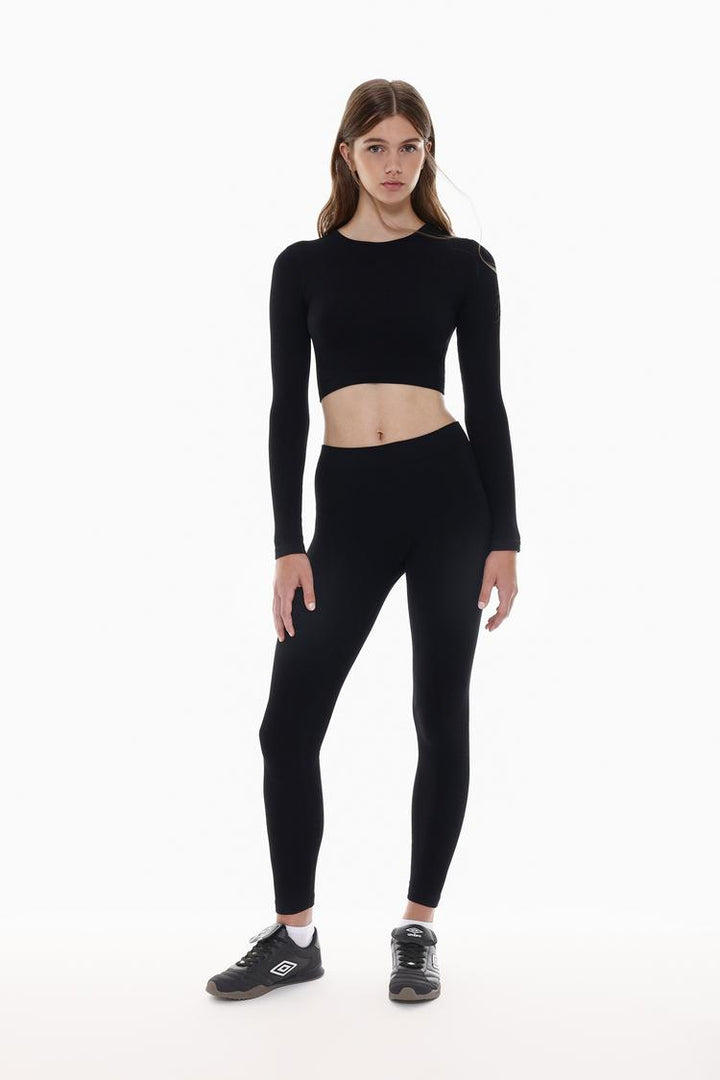 Full-body shot showcasing the black seamless leggings styled for comfort and performance.