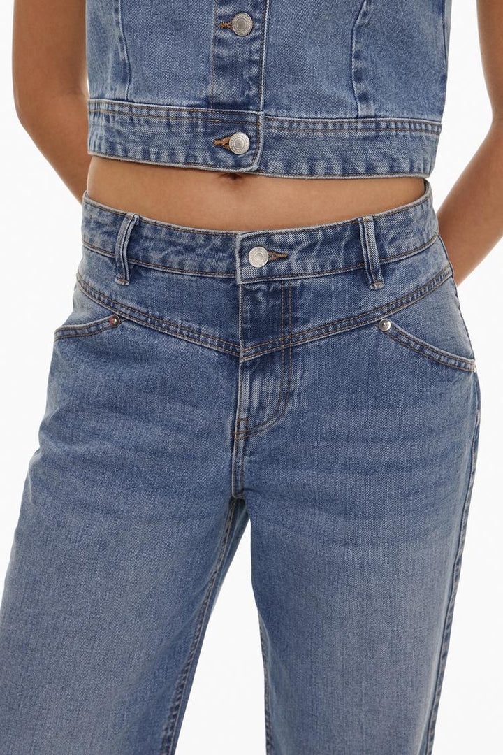 Close-up view of the waist detail, emphasizing the unique design, high-quality stitching, and refined finish.

