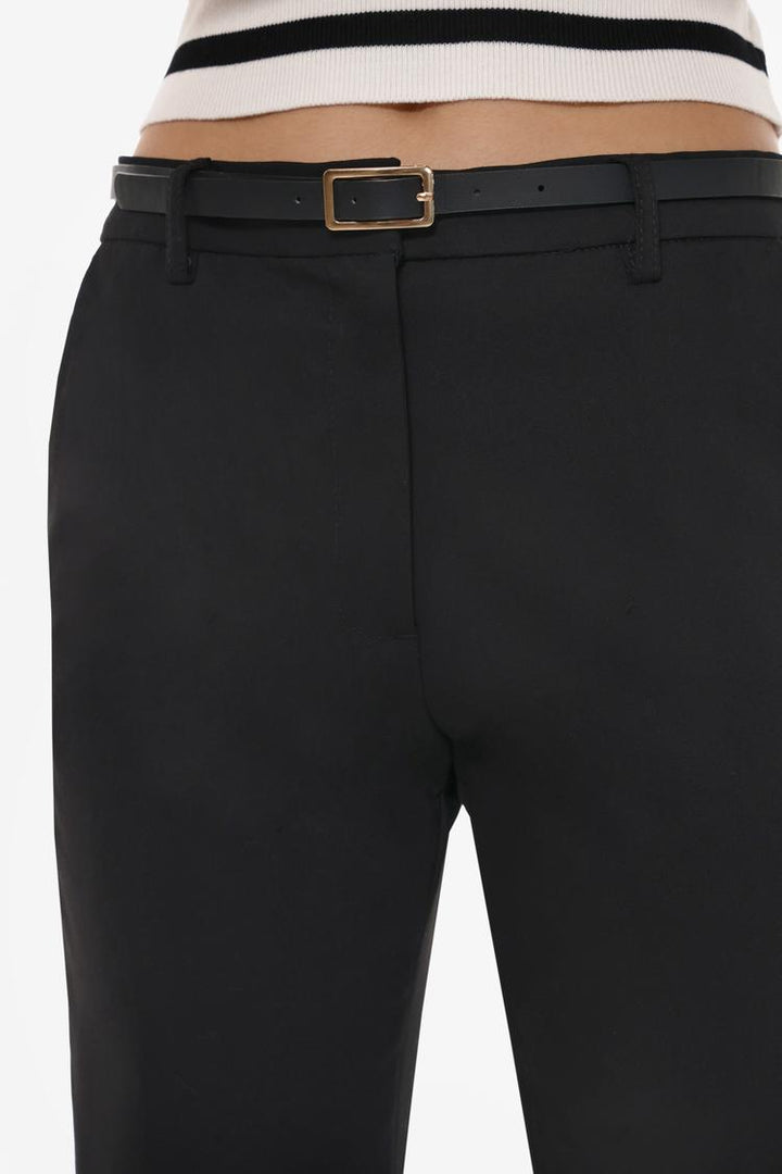 Full product view of black slim fit trousers with a belt, crafted for a versatile wardrobe