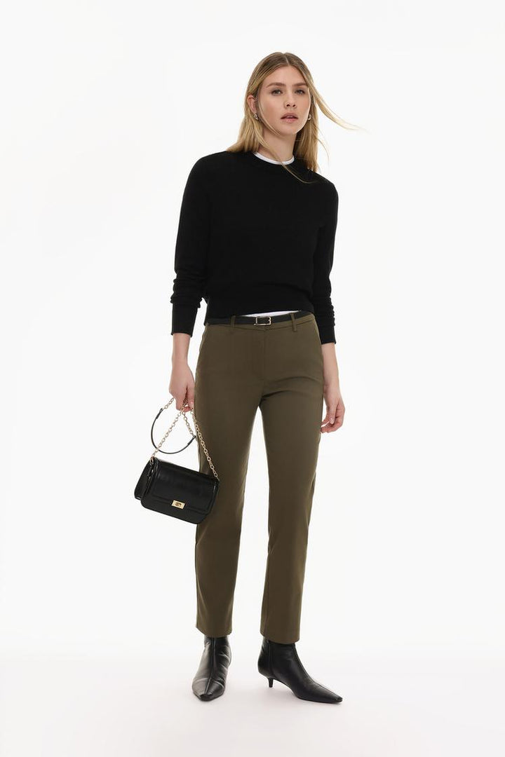 Front view of brown slim fit trousers with a belt, tailored for modern aesthetics