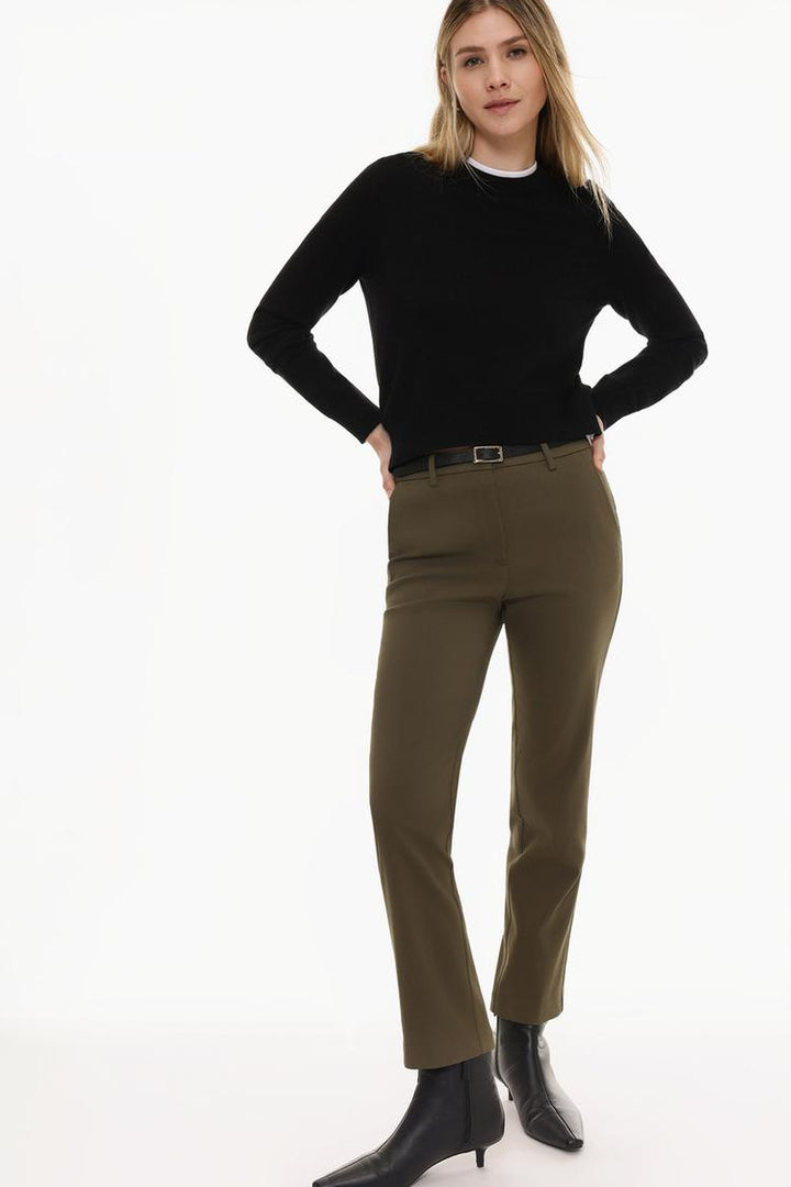 Full-body display of brown slim fit trousers with a belt, styled for a sophisticated look