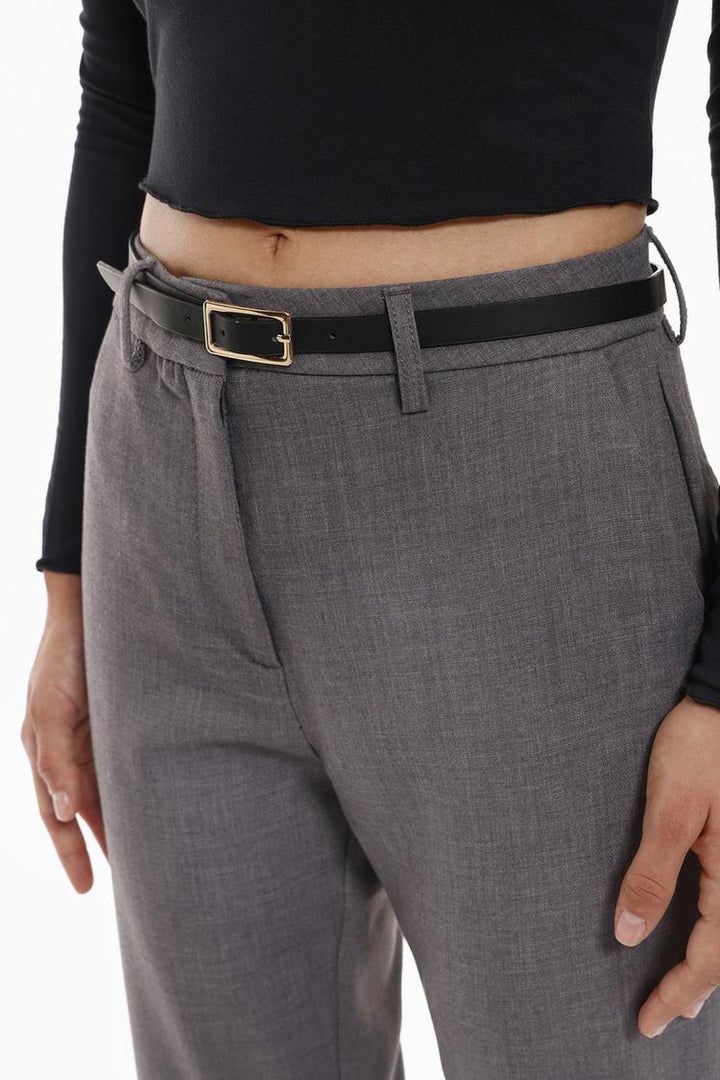 Full-body display of grey slim fit trousers with a belt, styled for a sharp look