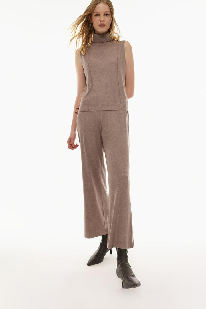 A full-body image of the brown trousers styled with complementary attire, ideal for giving customers a complete look.