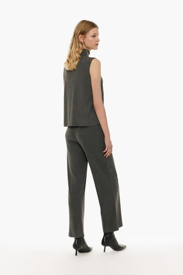 Back view of the grey soft-touch trousers, showcasing the precise tailoring and clean silhouette.