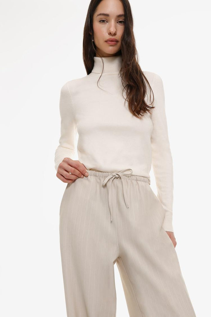 Beige straight-fit trousers, adding neutral sophistication to your outfit choices