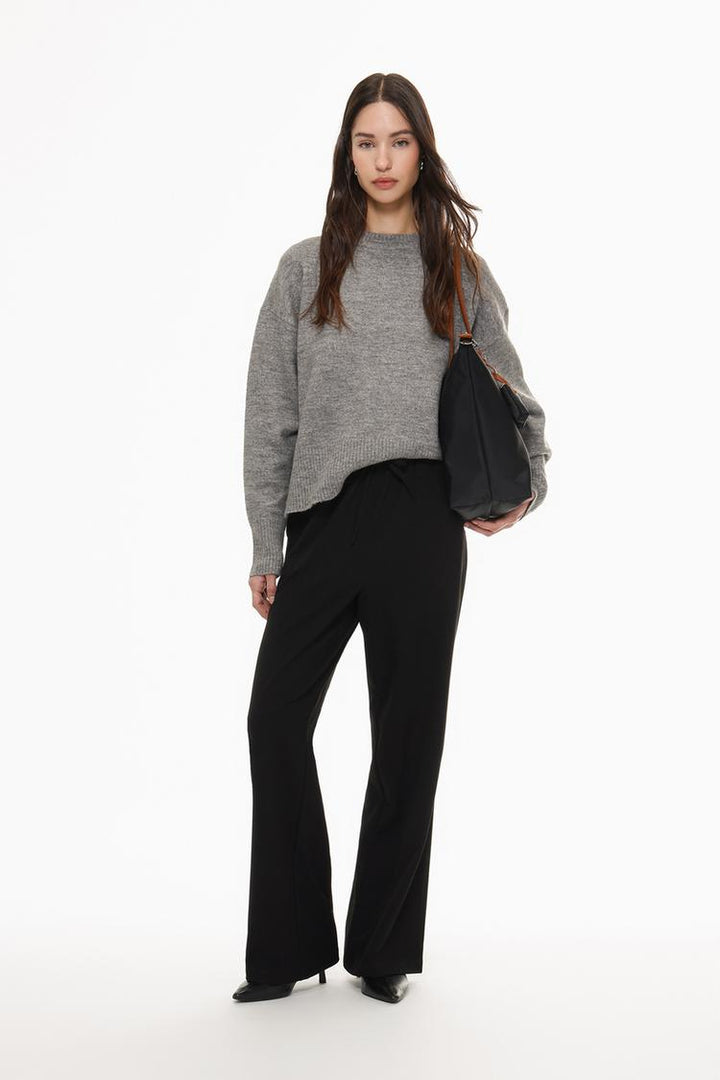 Full-body display of black straight-fit trousers styled for everyday wear inspiration