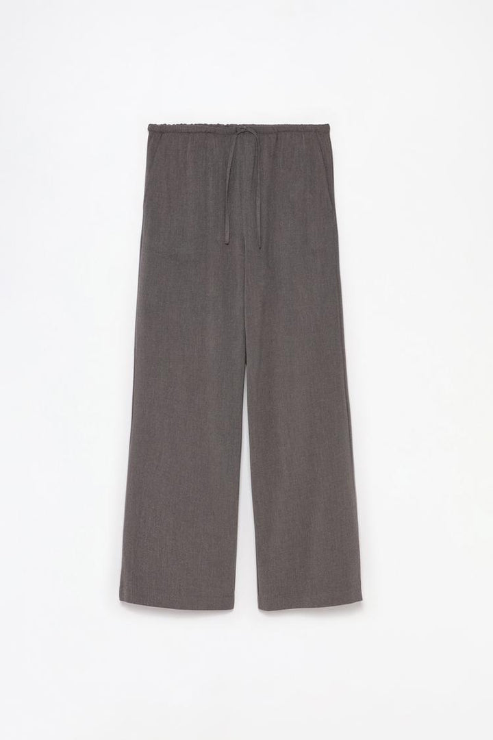 Full-body display of grey straight-fit trousers styled for professional or casual outfits