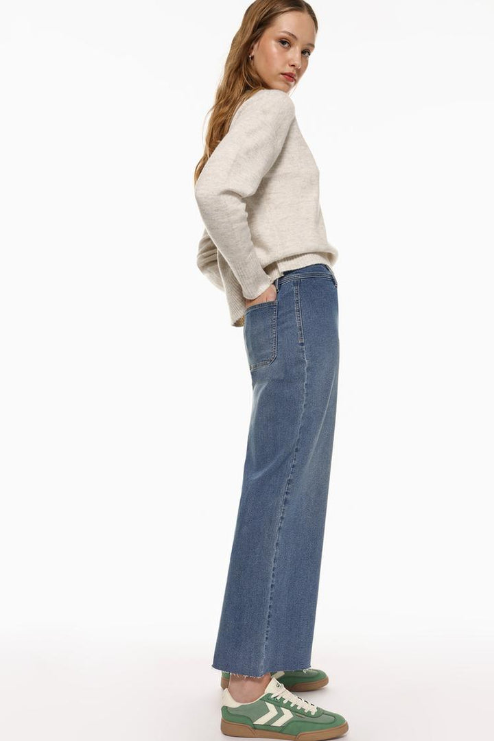 Styled look demonstrating how the jeans complement different outfits.