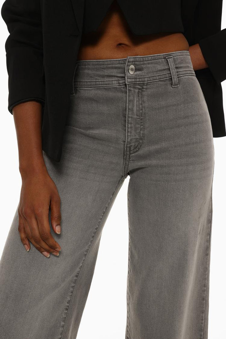 Model wearing the jeans, demonstrating their relaxed yet elegant silhouette.