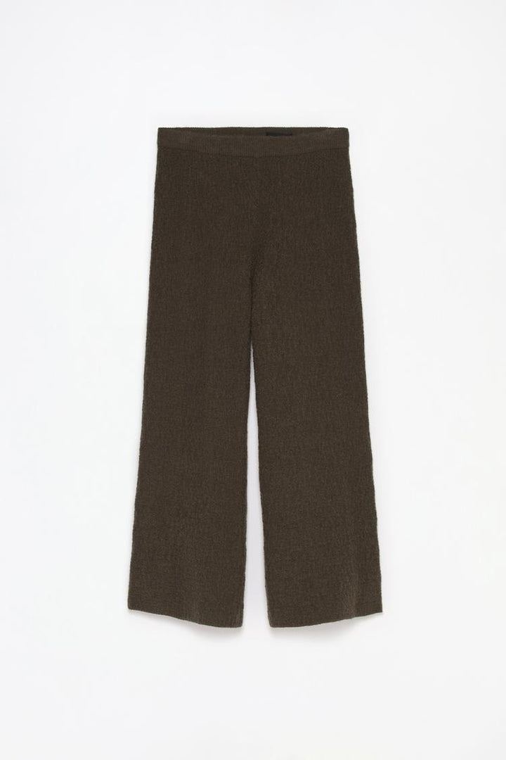 Comprehensive product view of the green textured knit trousers, showcasing their unique texture and structure.