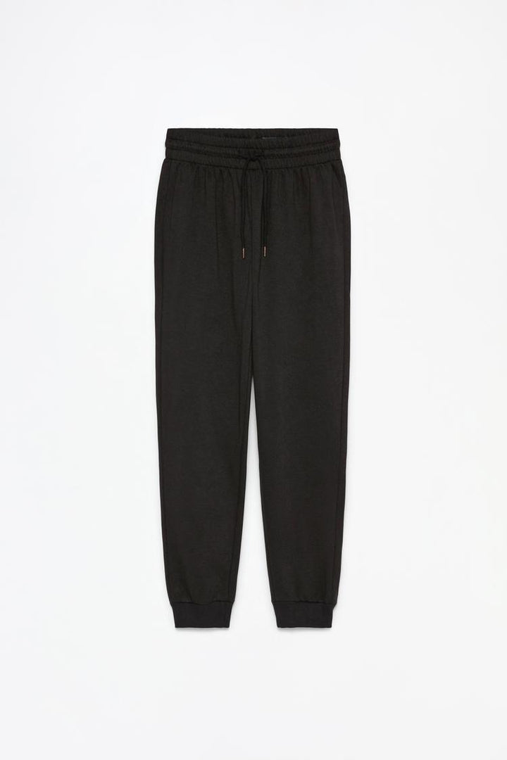 Full product image of black tracksuit bottoms displaying complete design.