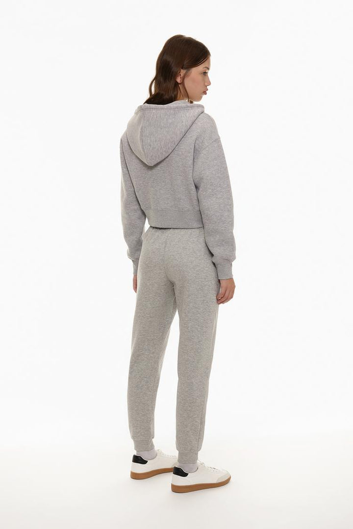 Back view of grey tracksuit bottoms showing the relaxed fit and design.