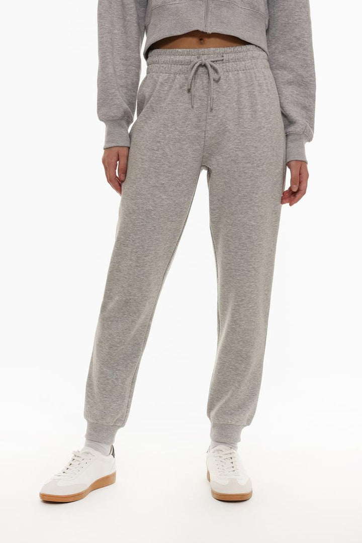 Grey tracksuit bottoms front view showing the fit and style.