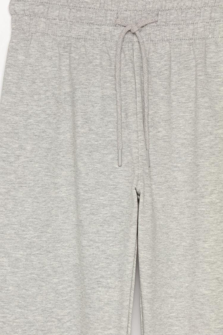 Grey tracksuit bottoms product image displaying the overall look.