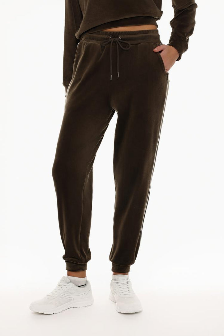 Front view of brown velvet joggers displaying the waist and leg fit.