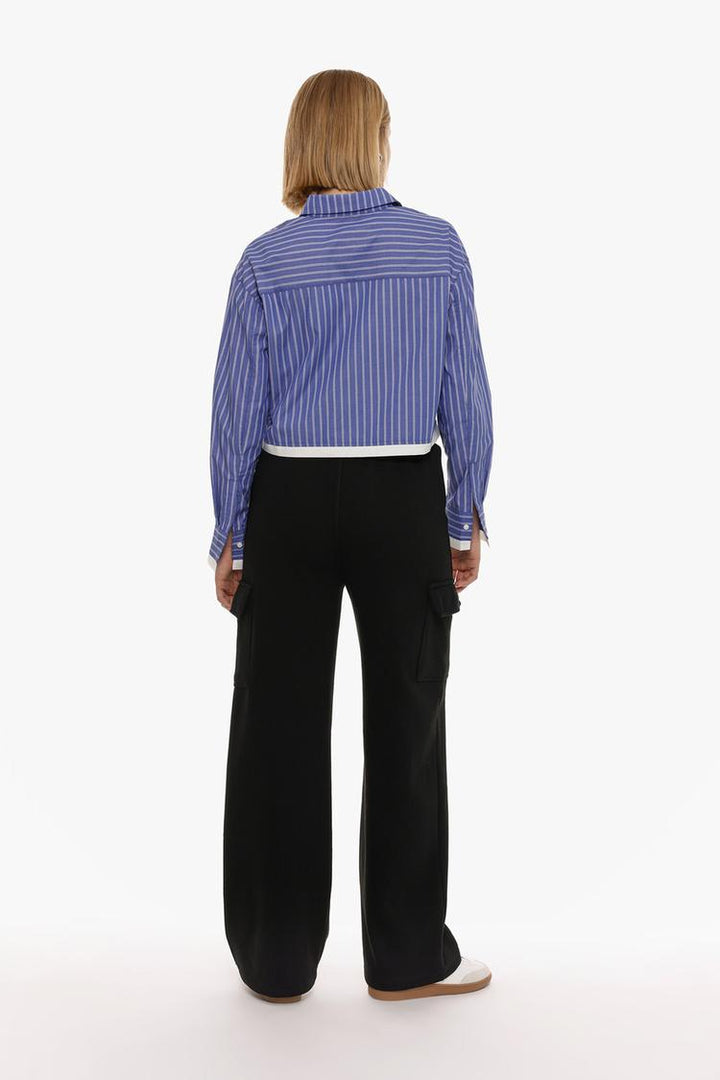 Back view of the black wide-leg cargo trousers, showing the fit and detailing around the waistband and pockets.