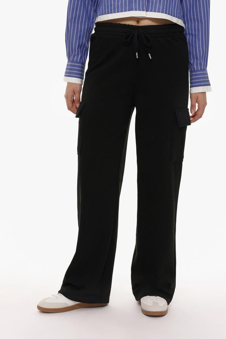 Front view of the black wide-leg cargo trousers, displaying the wide-leg silhouette and the utility-style pockets.