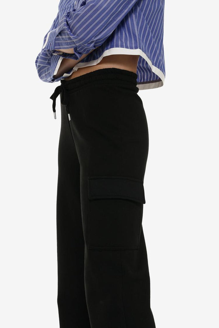 Side view of the black wide-leg cargo trousers, showcasing the relaxed and roomy fit with a focus on the overall shape.