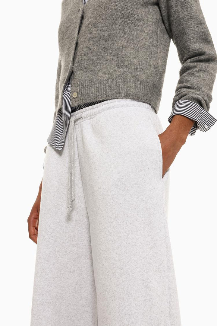 Full product view of grey wide-leg plush trousers displaying the complete design.