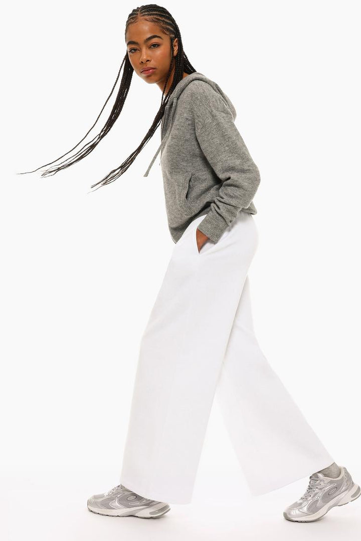 Full product view of white wide-leg plush trousers showcasing the design.