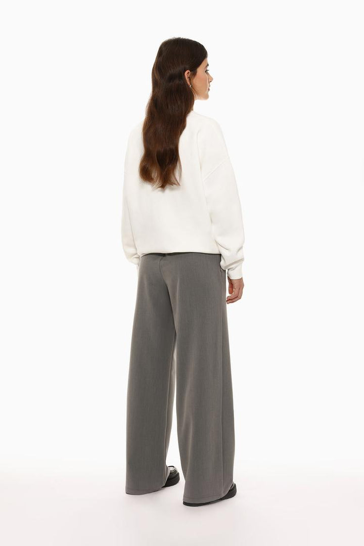 Back view of grey wide-leg smart trousers, demonstrating the clean and polished cut