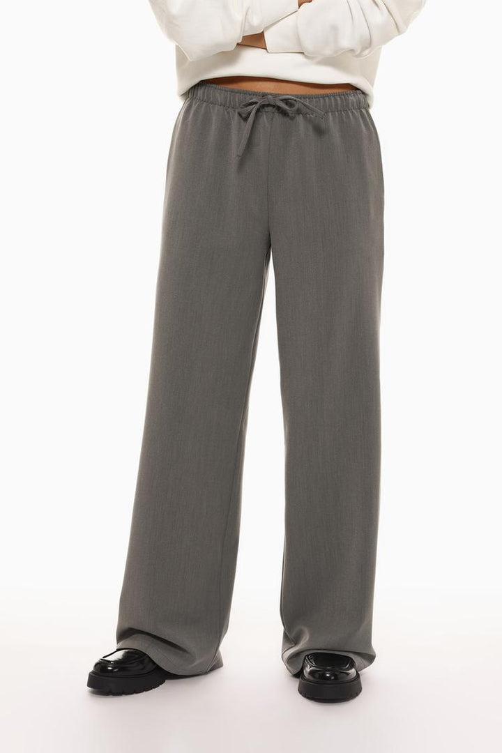 Front view of grey wide-leg smart trousers, highlighting their sleek and modern design