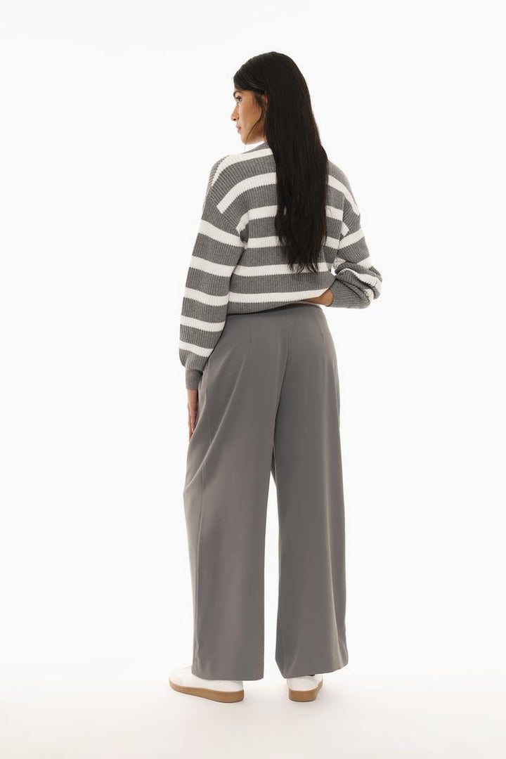 Rear view of the trousers, highlighting the clean lines and relaxed fit of the wide-leg silhouette.