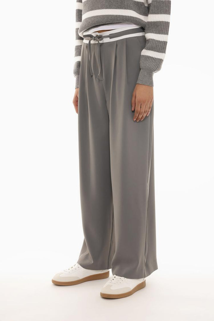 Front view displaying the structured waistband and wide-leg design, offering a blend of style and comfort.