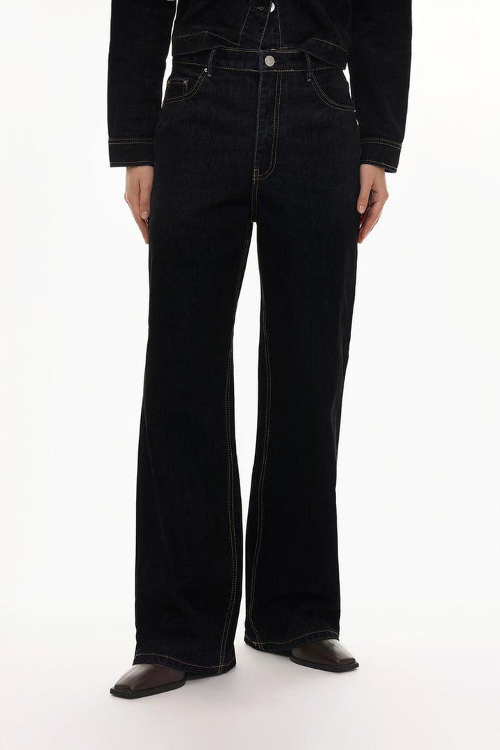 Front view of the velvety jeans, highlighting the high-waist design and flowy wide-leg cut for a flattering look.

