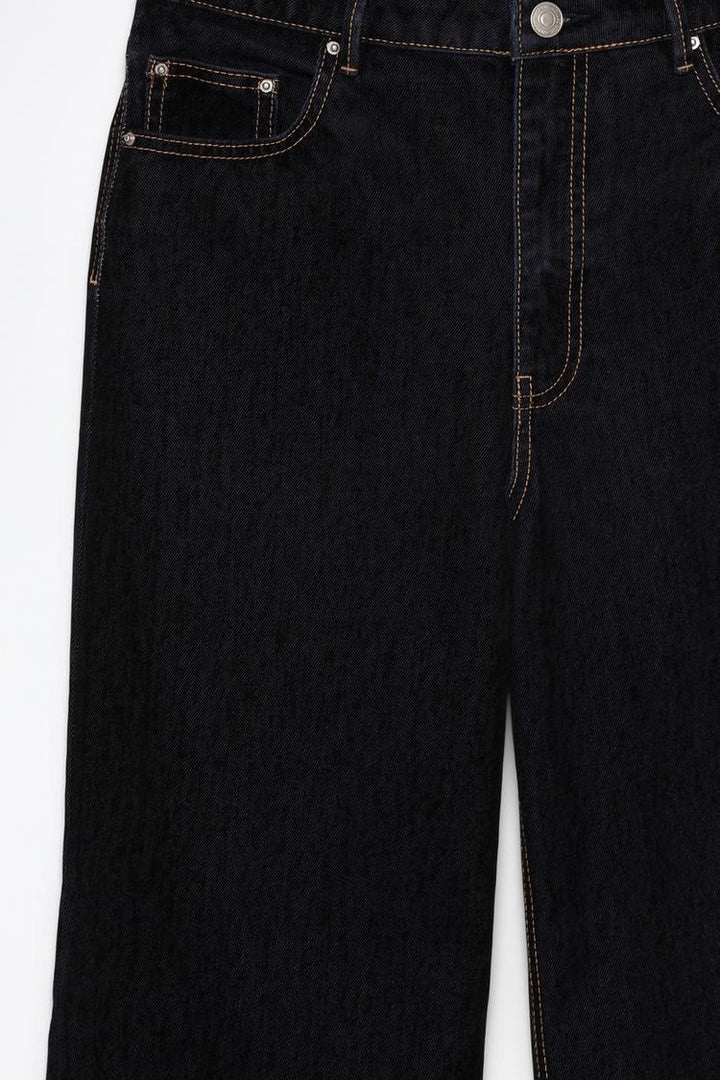 Close-up of the velvety jeans, focusing on the plush fabric, precise tailoring, and high-quality finish.